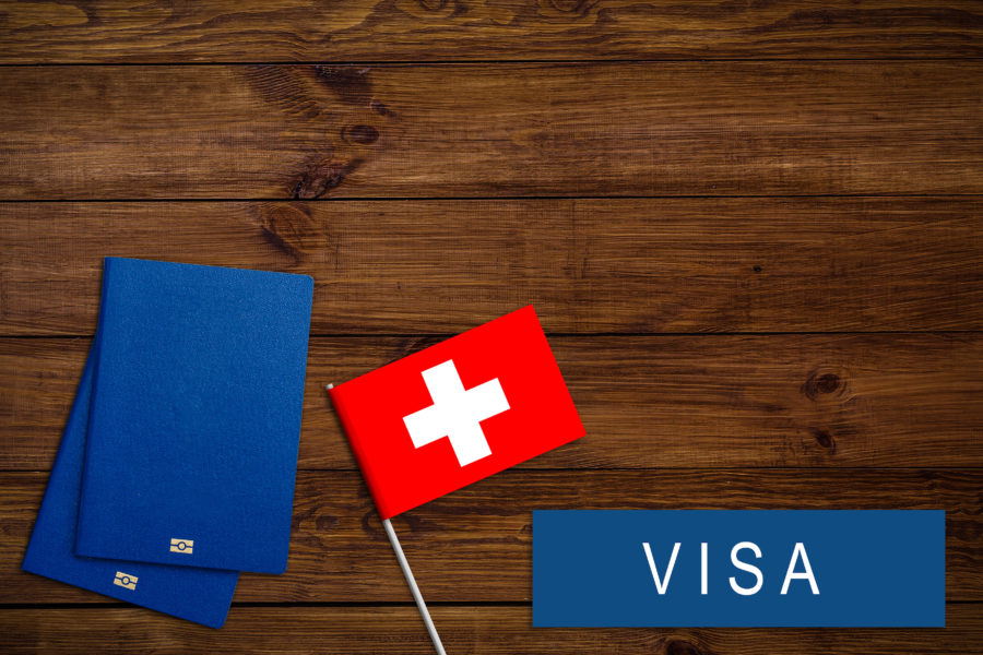 text VISA on Swiss visa passport, passport traveling abroad concept. Visit, Travel to Swiss concept - selective focus. Immigration and emigration concept